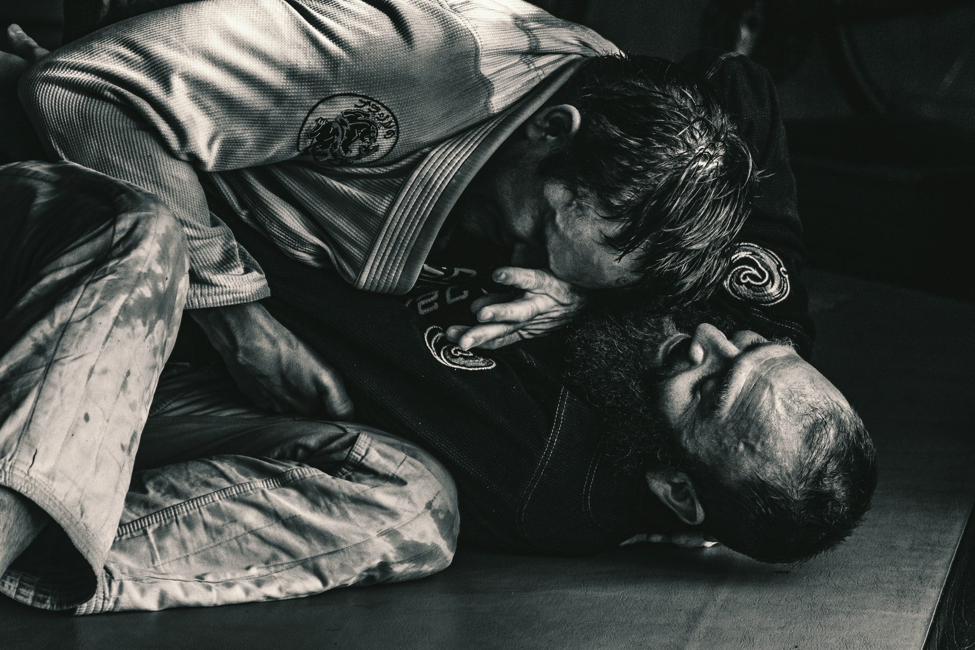 Two athletes practicing jiu-jitsu.