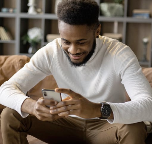 Image of a man texting on his mobile phone